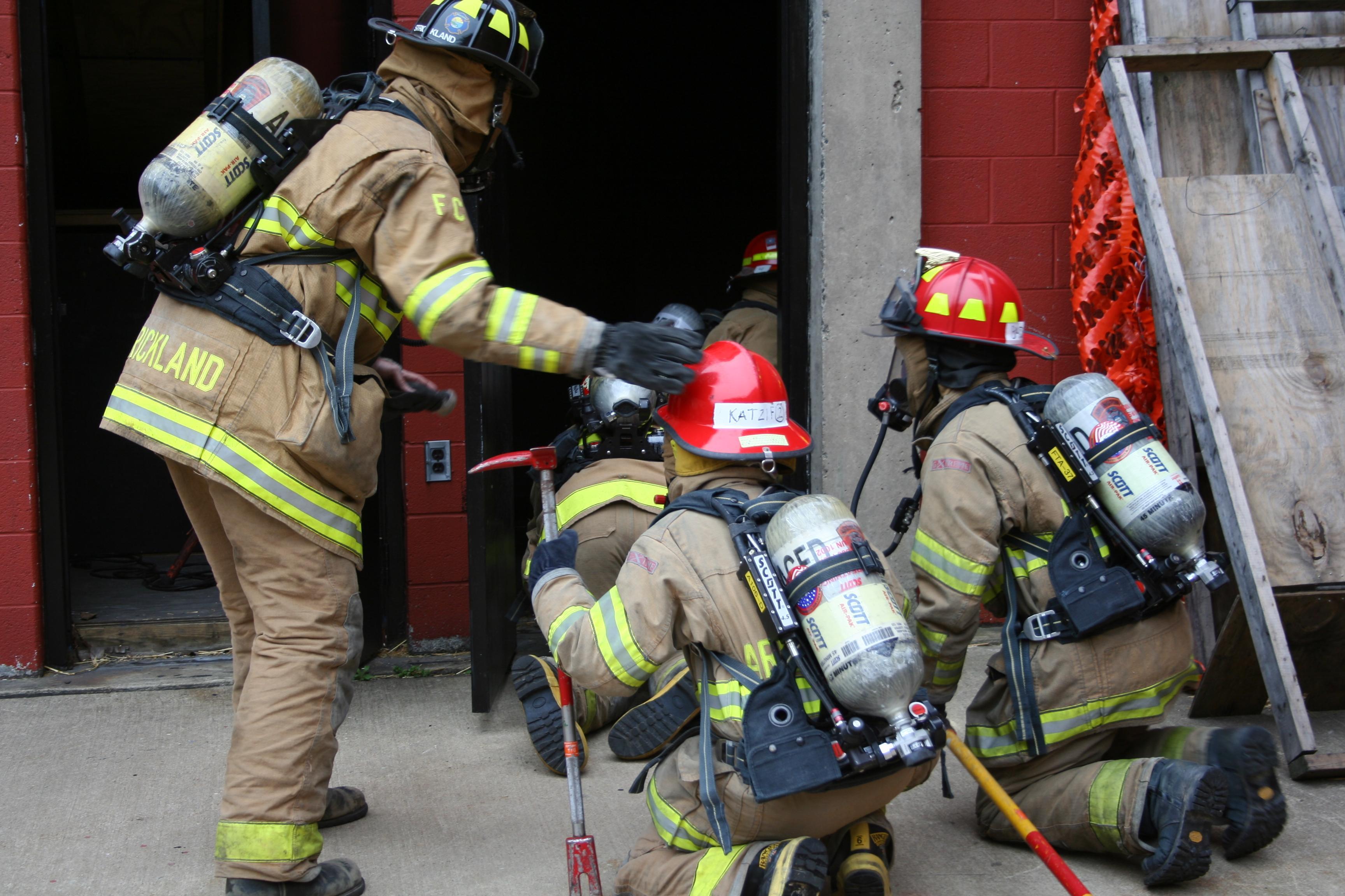 firefighters entering a building firefighters entering a building