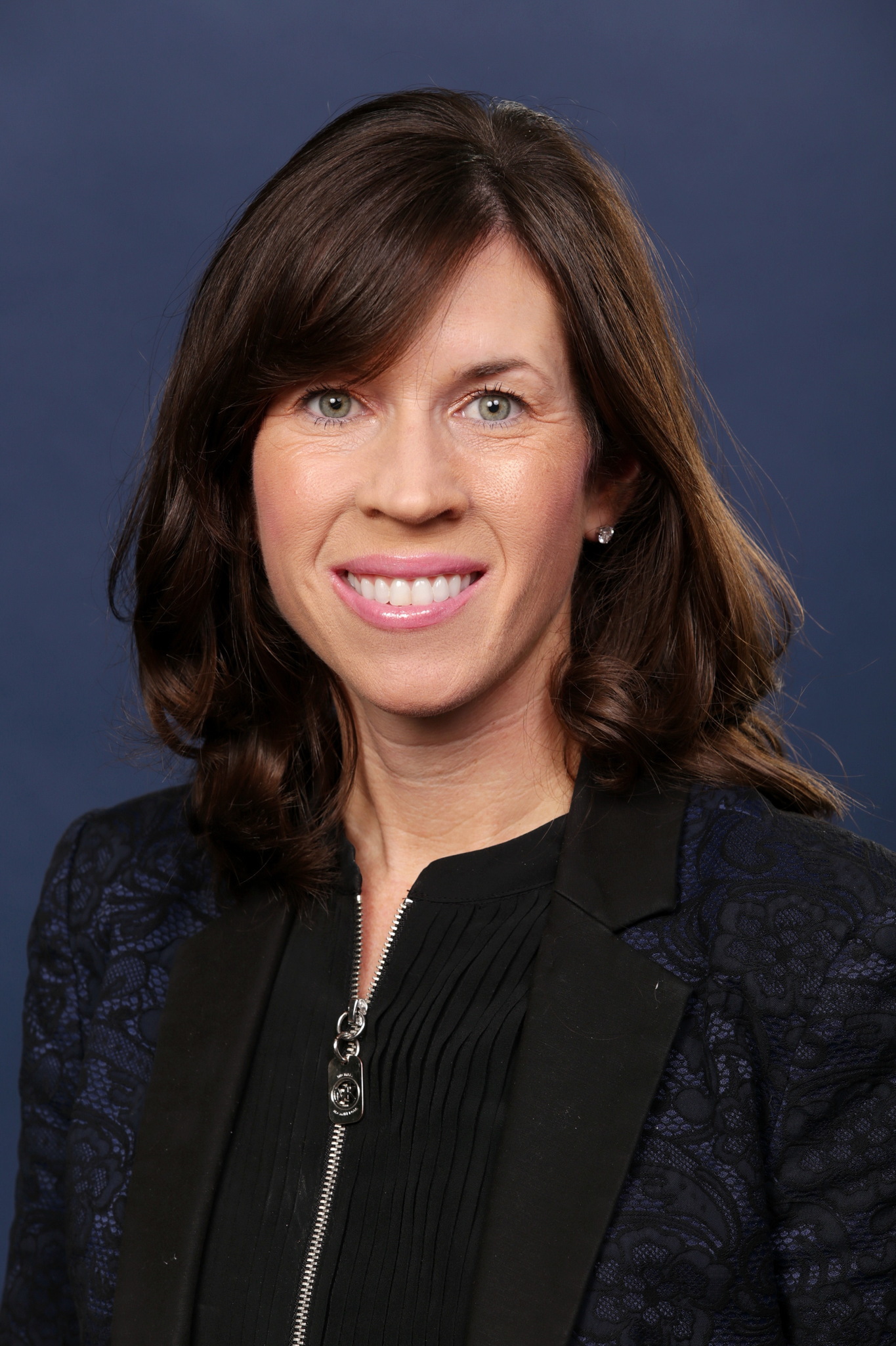 white woman with dark brown hair and dark zip-up jacket